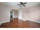 Inviting living room featuring gleaming hardwood floors, an archway, and abundant natural light streaming through the windows at 732 S Biltmore Ave, Indianapolis, IN 46241