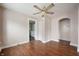 Inviting living room featuring gleaming hardwood floors, an archway, and abundant natural light streaming through the windows at 732 S Biltmore Ave, Indianapolis, IN 46241