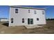 Newly built home with light gray siding and a sliding glass door leading to the backyard at 7323 Waylon Way, Indianapolis, IN 46239