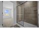 Modern bathroom featuring a tiled shower and view into the walk-in closet at 7323 Waylon Way, Indianapolis, IN 46239