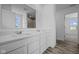 Bathroom with a double sink vanity, quartz countertop, and wood-look flooring at 7323 Waylon Way, Indianapolis, IN 46239