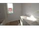 Bathroom with a window and a dual sink vanity, awaiting final touches at 7323 Waylon Way, Indianapolis, IN 46239