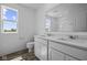Bathroom featuring a double sink vanity, quartz countertop, and wood-look flooring at 7323 Waylon Way, Indianapolis, IN 46239