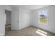 Bright bedroom with closet, attached bathroom, a large window, and neutral colored walls at 7323 Waylon Way, Indianapolis, IN 46239