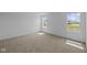 Bedroom with natural light, neutral carpet, and serene neighborhood view at 7323 Waylon Way, Indianapolis, IN 46239