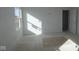 A bright bedroom featuring a window allowing natural light and freshly painted white walls at 7323 Waylon Way, Indianapolis, IN 46239