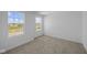 Neutral carpeted bedroom provides a bright view outside from the double windows at 7323 Waylon Way, Indianapolis, IN 46239