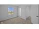 Bright bedroom featuring neutral carpet, closet with sliding doors, and a backyard view at 7323 Waylon Way, Indianapolis, IN 46239