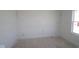 A bedroom featuring a window, neutral colors, base trim, and electrical outlets at 7323 Waylon Way, Indianapolis, IN 46239