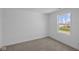 Bright bedroom featuring neutral carpet, clean walls, and a view of the backyard at 7323 Waylon Way, Indianapolis, IN 46239