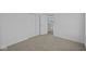 Bright bedroom featuring neutral carpet, closet with sliding doors, and an open doorway at 7323 Waylon Way, Indianapolis, IN 46239
