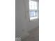 A bedroom featuring a window, neutral colors, base trim, and an electrical outlet at 7323 Waylon Way, Indianapolis, IN 46239