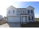 Charming two-story home with gray siding, white trim, an attached garage and a well-lit front porch at 7323 Waylon Way, Indianapolis, IN 46239
