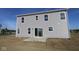 Two-story house featuring gray siding, white trim, and a concrete patio with sliding glass doors at 7323 Waylon Way, Indianapolis, IN 46239
