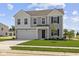 Charming two-story home with gray siding, a two-car garage, and a well-manicured lawn at 7323 Waylon Way, Indianapolis, IN 46239