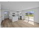 Open kitchen with white cabinets, stainless steel appliances, and sliding glass doors at 7323 Waylon Way, Indianapolis, IN 46239