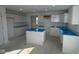 Bright and spacious kitchen featuring white cabinets, an island and modern design elements at 7323 Waylon Way, Indianapolis, IN 46239