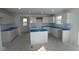 Bright and spacious kitchen featuring white cabinets, an island and modern design elements at 7323 Waylon Way, Indianapolis, IN 46239