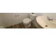 Compact bathroom featuring a toilet and a sleek, modern sink at 7329 Waylon Way, Indianapolis, IN 46239