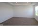 Spacious bedroom featuring a tray ceiling, neutral carpet, and a bright window at 7329 Waylon Way, Indianapolis, IN 46239
