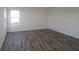 Bright bedroom with stylish wood-look floors and a large window at 7329 Waylon Way, Indianapolis, IN 46239