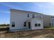 Exterior home view shows white siding and a sunroom addition with sliding door at 7329 Waylon Way, Indianapolis, IN 46239