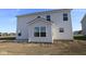 Back of the home featuring white siding, lots of windows, and a sunroom addition at 7329 Waylon Way, Indianapolis, IN 46239