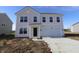 Charming two-story home features a two-car garage and a classic light gray exterior at 7329 Waylon Way, Indianapolis, IN 46239