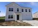Charming two-story home features a two-car garage and a classic light gray exterior at 7329 Waylon Way, Indianapolis, IN 46239