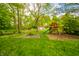 Spacious backyard featuring a playground and shed, ideal for Gathering fun at 806 Maplewood Ave, Anderson, IN 46012