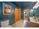 Inviting bathroom with blue walls, wooden cabinets, and tiled flooring at 806 Maplewood Ave, Anderson, IN 46012