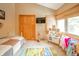 Bright bedroom featuring a closet, a television, and play area at 806 Maplewood Ave, Anderson, IN 46012