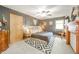 A modern bedroom featuring a wooden bed frame, dark gray walls, and a striking geometric rug at 806 Maplewood Ave, Anderson, IN 46012