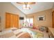 Bright bedroom featuring a ceiling fan, play area, and closet at 806 Maplewood Ave, Anderson, IN 46012