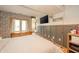 Well-lit bedroom featuring a window and wood paneling at 806 Maplewood Ave, Anderson, IN 46012