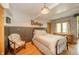 Well-lit bedroom featuring a window and a vintage wooden sign at 806 Maplewood Ave, Anderson, IN 46012