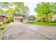 Charming two-story home features a long driveway, inviting curb appeal, and lush green landscaping at 806 Maplewood Ave, Anderson, IN 46012