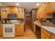 Bright kitchen with wood cabinets and modern appliances for a functional cooking space at 806 Maplewood Ave, Anderson, IN 46012