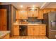 Well-lit kitchen features wood cabinets, sleek appliances, and ample counter space at 806 Maplewood Ave, Anderson, IN 46012