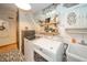 Clean laundry room with appliances, utility sink, and space-saving storage features at 806 Maplewood Ave, Anderson, IN 46012