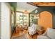 Bright sunroom with many plants and natural lighting at 806 Maplewood Ave, Anderson, IN 46012