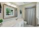Bathroom with vanity, large mirror, and a window overlooking the lush backyard at 8218 San Carlos Ct, Indianapolis, IN 46256