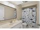 This full bathroom includes a single sink vanity, a toilet, and a shower with a fun shark-themed curtain at 8218 San Carlos Ct, Indianapolis, IN 46256