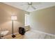 Bedroom with a fan, large window, and a dedicated workspace area at 8218 San Carlos Ct, Indianapolis, IN 46256