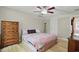 Bedroom with a ceiling fan, two dressers, and colorful patterned bedding at 8218 San Carlos Ct, Indianapolis, IN 46256
