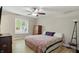 Cozy bedroom featuring a ceiling fan, window, and colorful patterned bedding at 8218 San Carlos Ct, Indianapolis, IN 46256
