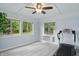 The bonus room includes a ceiling fan, three windows, an AC unit, and a treadmill at 8218 San Carlos Ct, Indianapolis, IN 46256