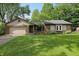 Charming single-story home with a brick facade, well-maintained lawn, and attached two-car garage at 8218 San Carlos Ct, Indianapolis, IN 46256