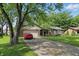 Lovely single-story home with a mature tree, brick facade, and a two-car garage at 8218 San Carlos Ct, Indianapolis, IN 46256