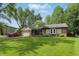 Inviting single-story brick home with lush green lawn and mature trees at 8218 San Carlos Ct, Indianapolis, IN 46256